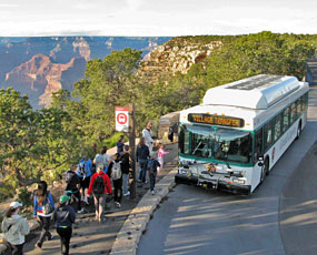 Hermit Shuttle Bus loading at Hermits Rest with canyon behind.