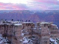 VISITORS AT SUNSET VIEWING GRAND CANYON N.P. FROM MATHER POINT ON THE S RIM AFTER A DUSTING OF WINTER SNOW. MIKE QUINN, NPS.