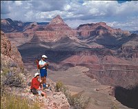 DAYHIKERS PAUSE TO VIEW THE CANYON ON THE GRANDVIEW TRAIL IN GRAND CANYON N.P. THE POINTED PEAK, BEHIND THEM IS VISHNU TEMPLE. MIKE QUINN, NPS.
