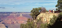 VISITORS WALKING ALONG THE RIM TRAIL IN THE HISTORIC SOUTH RIM VILLAGE. GRAND CANYON N. P. NPS PHOTO. 
